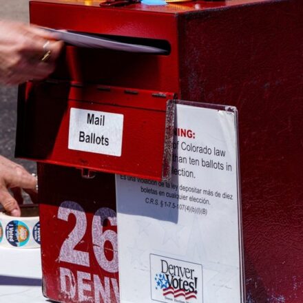 Erin Ludlam places a ballot in a drop-off box for the Democratic primaries at Blair-Caldwell Library, Tuesday, June 30, 2026, in Denver. (AP)