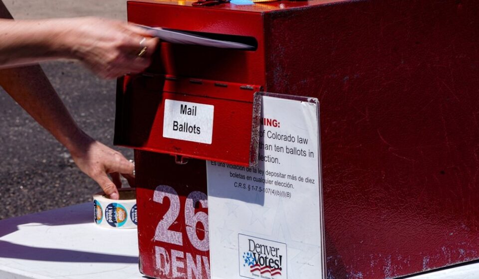 Erin Ludlam places a ballot in a drop-off box for the Democratic primaries at Blair-Caldwell Library, Tuesday, June 30, 2026, in Denver. (AP)