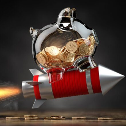Piggy bank on a flying rocket