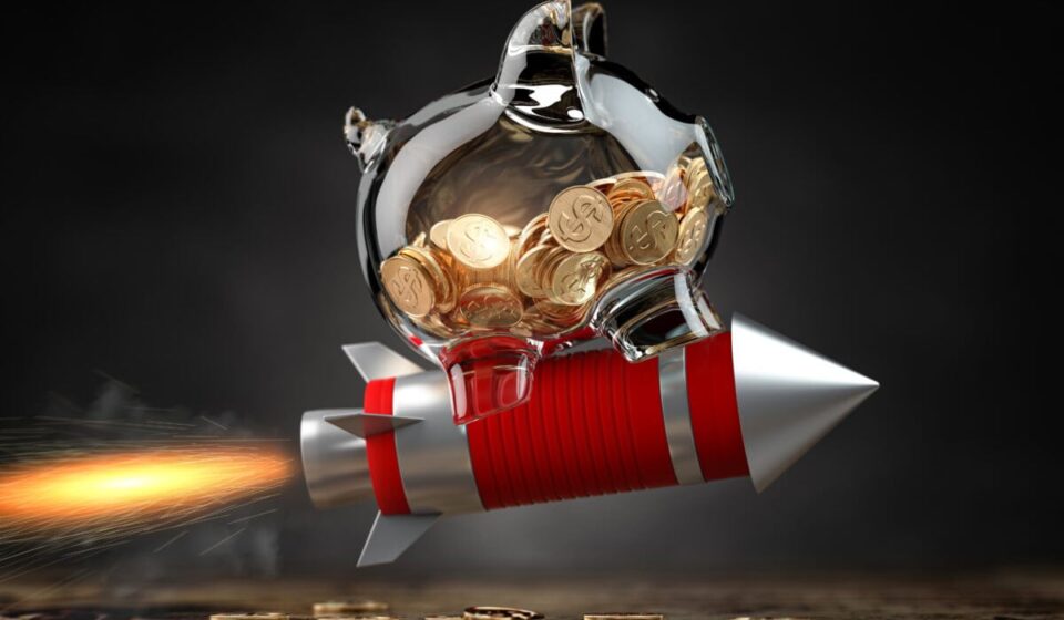 Piggy bank on a flying rocket