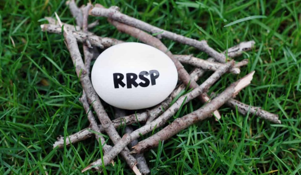 Close up of an egg in a nest of twigs on grass with RRSP written on it symbolizing a RRSP contribution.