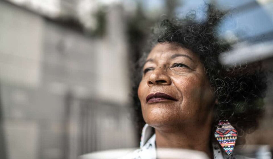 woman gazes forward out window to future