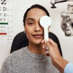 patient tests her eyes with a vision test at a doctor