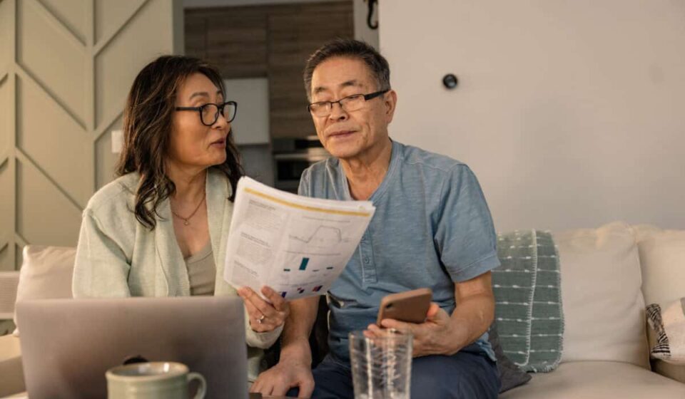 senior couple looks at investing statements